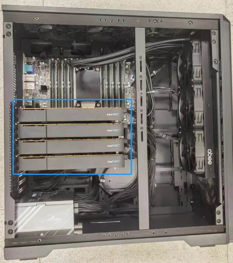 A black computer case with many wires and wires Des<i></i>cription automatically generated with medium confidence